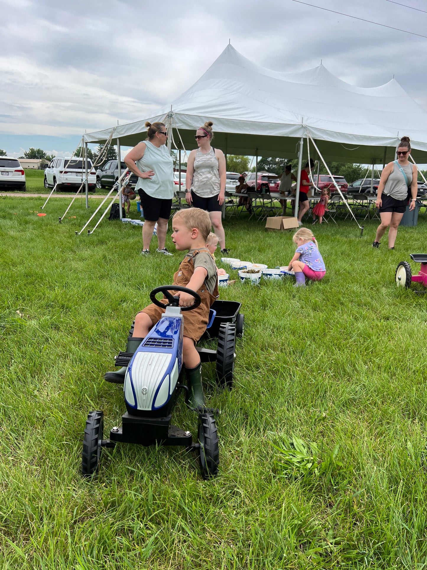 Young children enjoying Little Farmers Day on the Farm at Prairie Raised Beef—feeding baby calves, exploring sensory bins, and participating in farm-themed crafts.